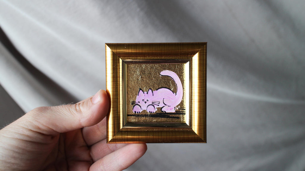 Hand-painted miniature pink cat oil painting with gold leaf background in a gold frame