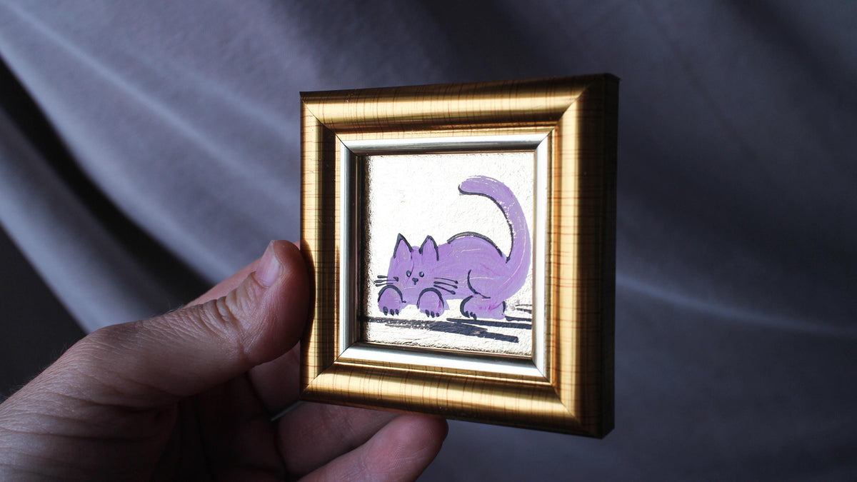 Hand-painted miniature pink cat oil painting with gold leaf background in a gold frame