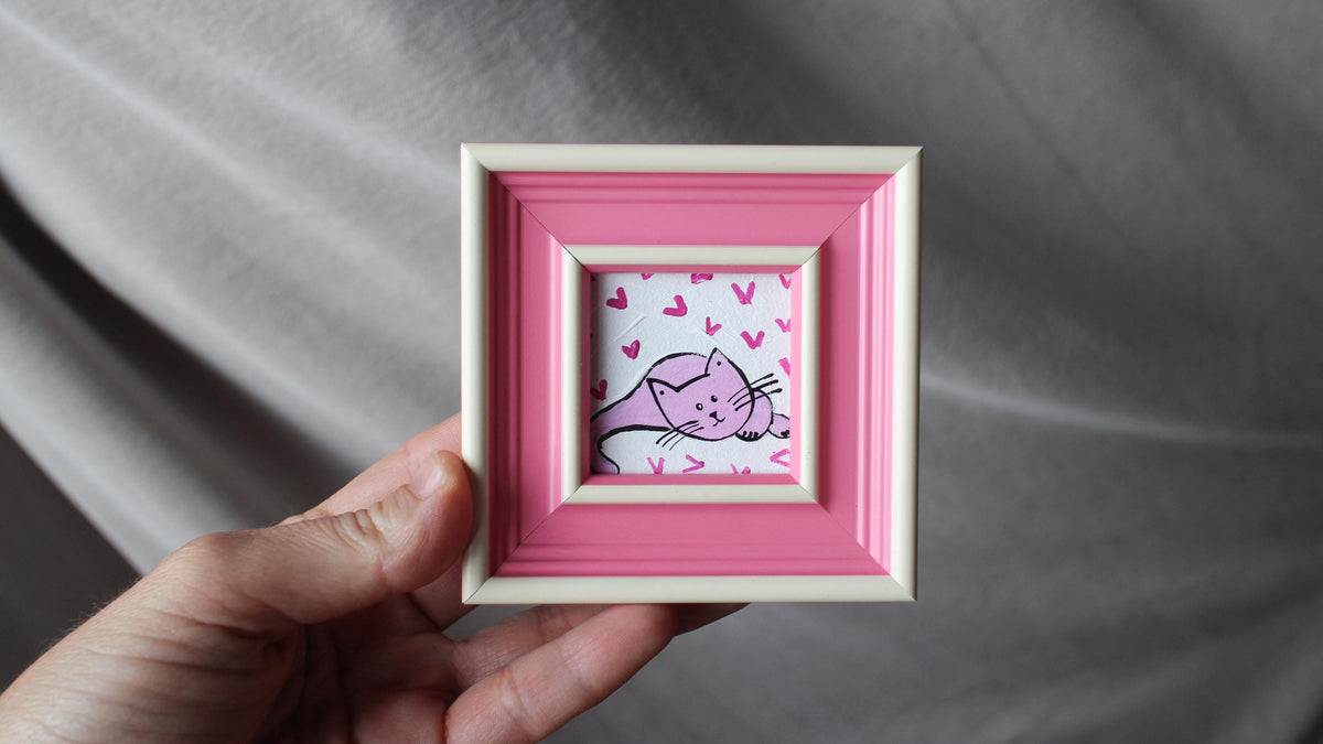 Hand-painted miniature tuxedo cat oil painting with gold leaf background in a yellow frame